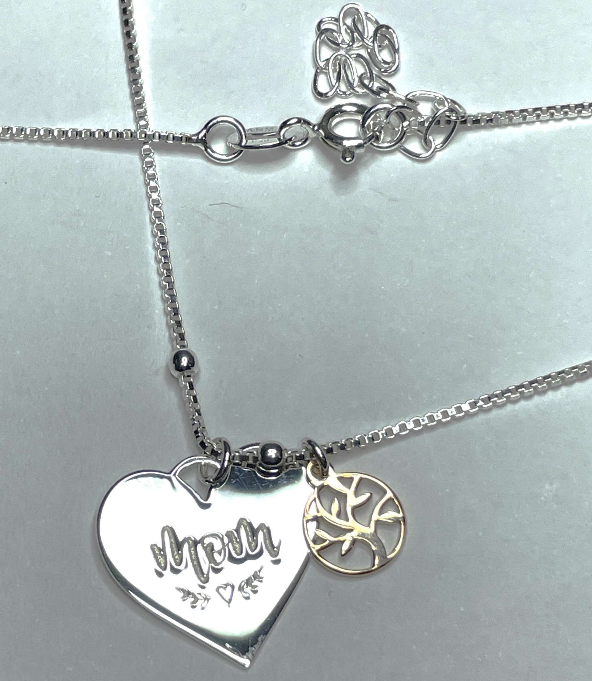 Sterling silver mom and family tree necklace with heart and vine detailing.