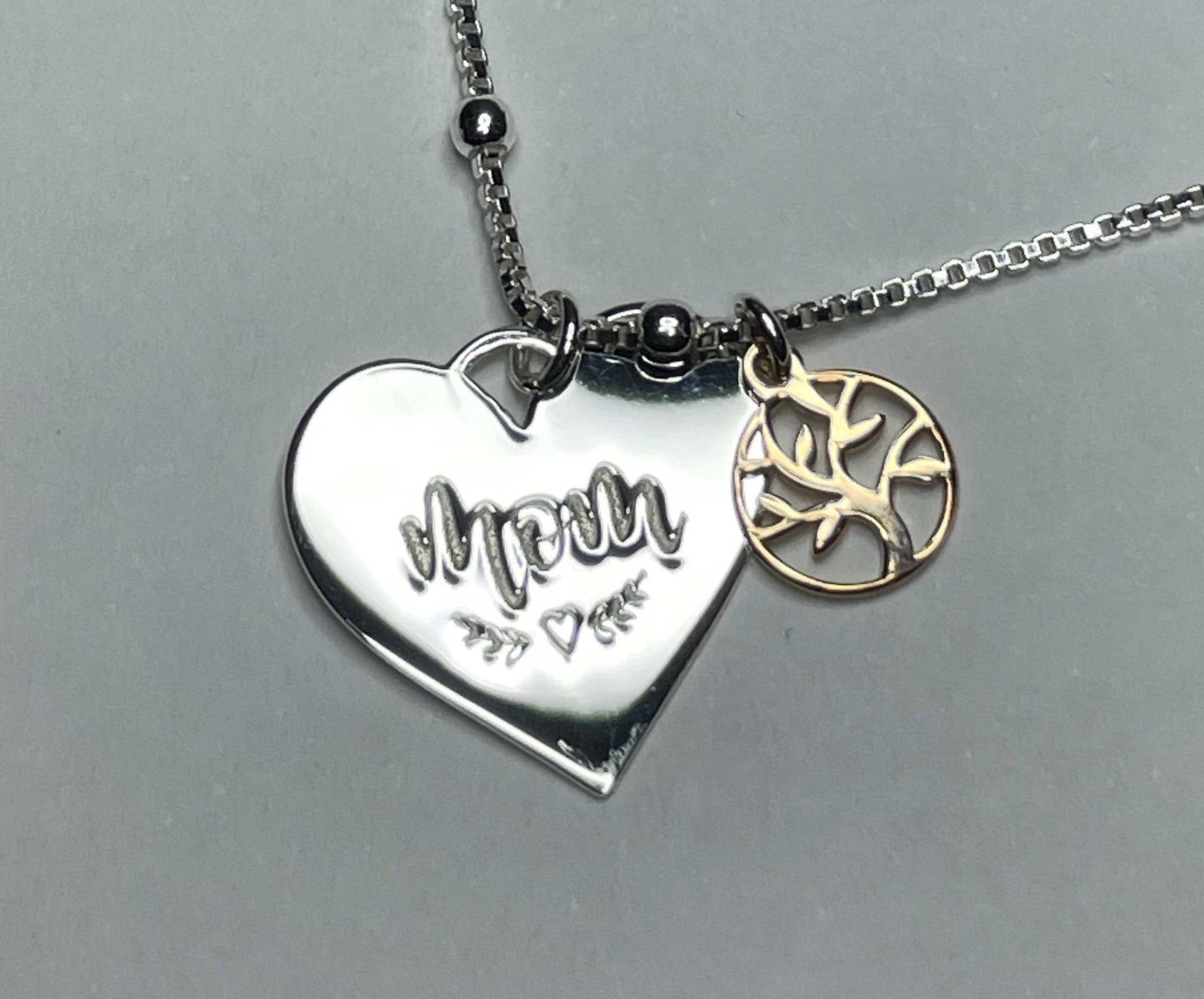 Sterling silver mom and family tree necklace with heart pendant and rose gold plated charm.