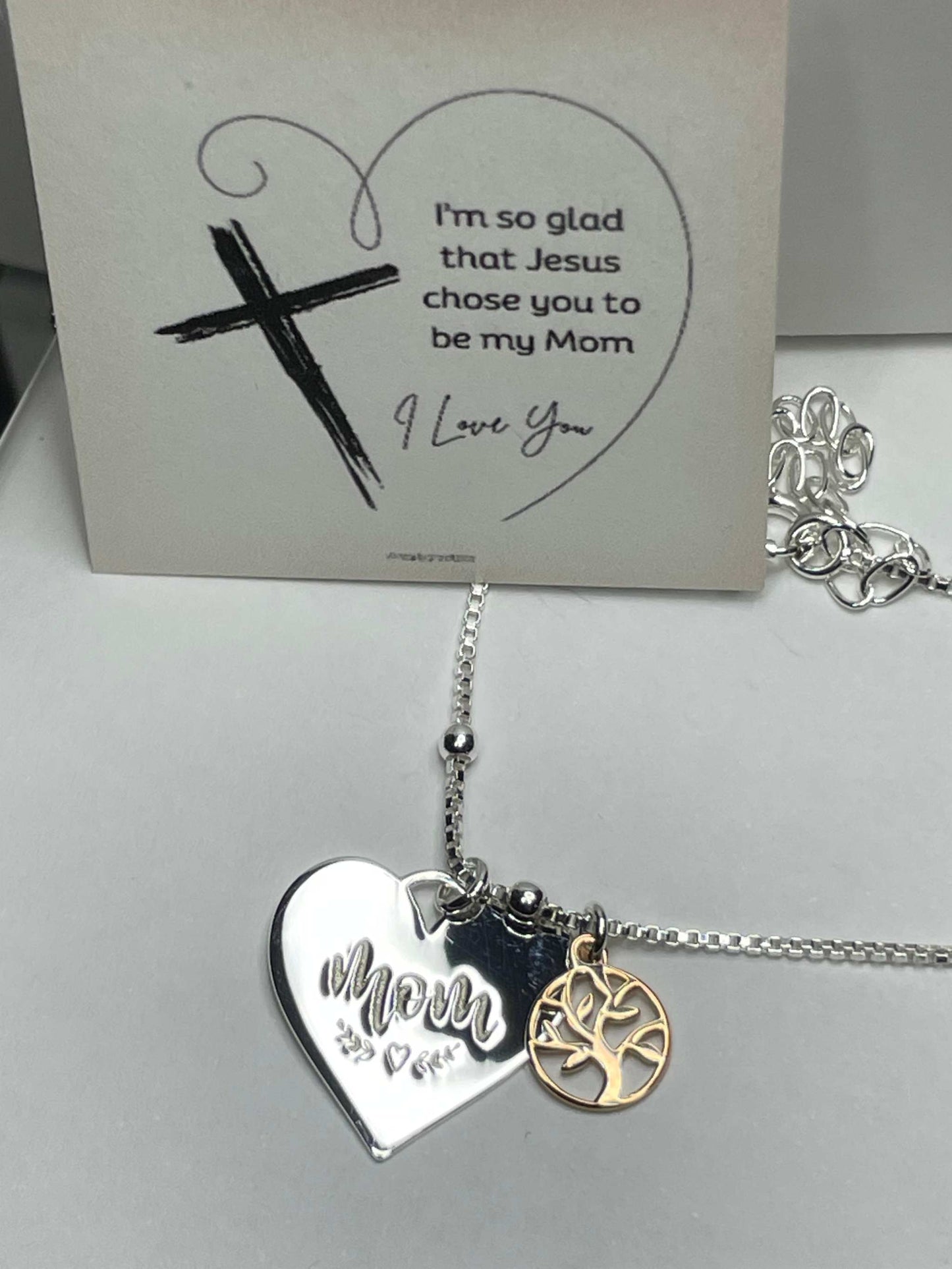 Sterling silver heart necklace with "Mom" engraving and rose gold family tree charm.